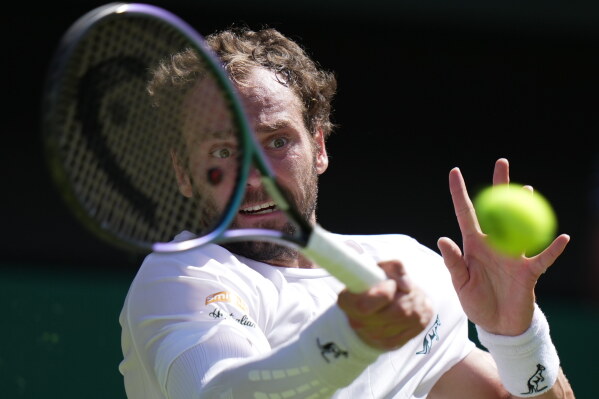 Roman Saffiulin of Russia returns the ball to Novak Djokovic of Serbia in their fourth round men's singles match at the Wimbledon Tennis Championships in London, Sunday, July 5, 2026. (AP Photo/Brian Inganga)