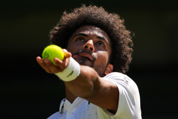 Arthur Fils of France serves the ball during the second round men's singles match against Matteo Berrettini of Italy at the Wimbledon Tennis Championships in London, Thursday, July 2, 2026.(AP Photo/Kirsty Wigglesworth)
