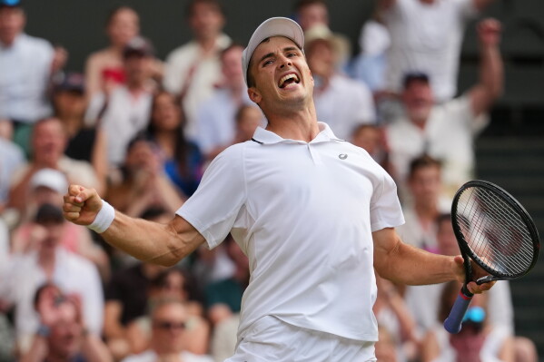Arthur Fery of Britain celebrates winning the fourth set during the men's singles fourth round match against Grigor Dimitrov of Bulgaria at the Wimbledon Tennis Championships in London, Monday, July 6, 2026.(AP Photo/Kirsty Wigglesworth)