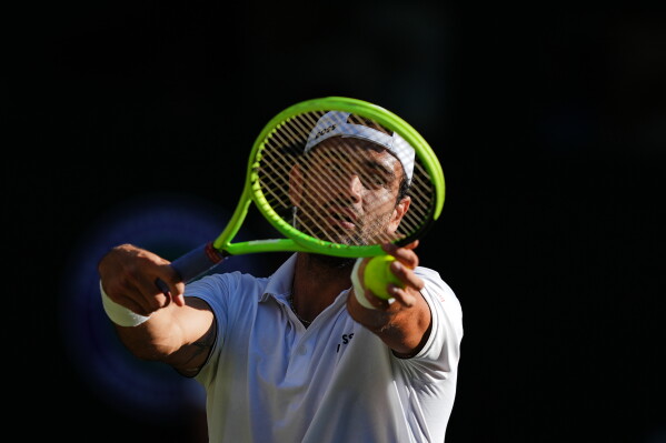 Matteo Berrettini of Italy serves during the third round men's singles match against Grigor Dimitrov of Bulgaria at the Wimbledon Tennis Championships in London, Saturday, July 4, 2026.(AP Photo/Maja Smiejkowska)