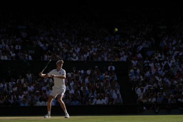 Jannik Sinner of Italy plays a return to Alexander Zverev of Germany men's singles final at Wimbledon Tennis Championships in London, Sunday, July 12, 2026. (AP Photo/Kin Cheung)