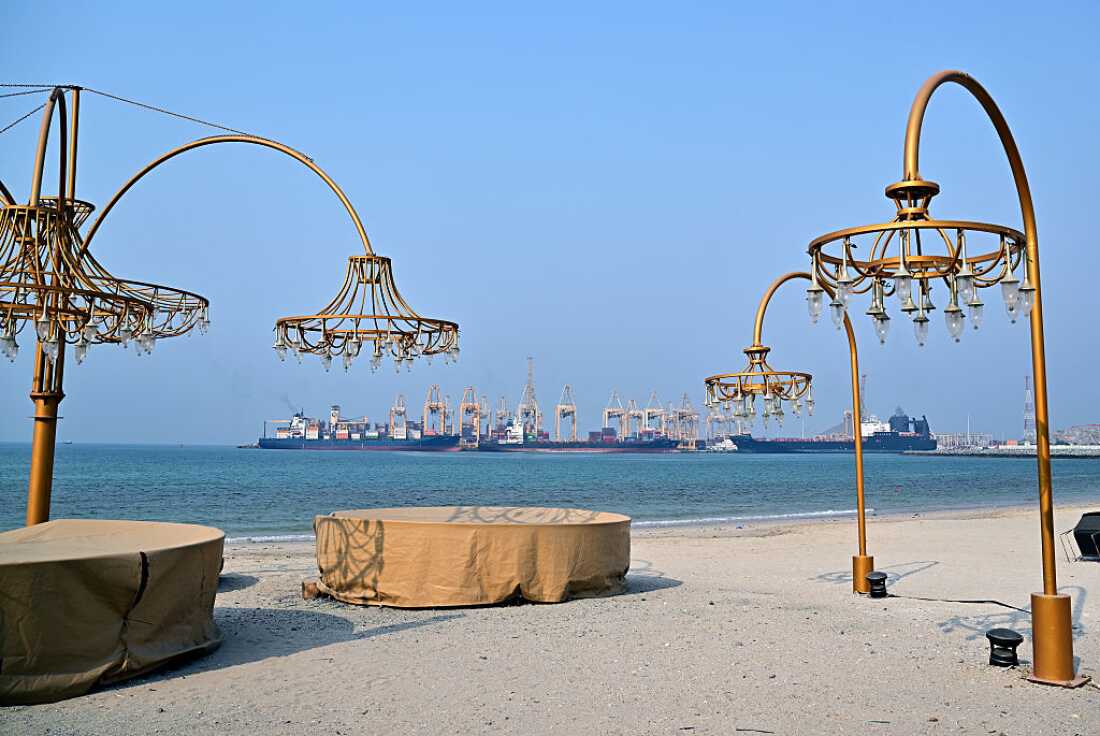 Ships are docked along a pier at the Khor Fakkan Container Terminal, the only natural deep-sea port in the region and one of the major container ports in Sharjah Emirate, along the Gulf of Oman on July 14, 2026.