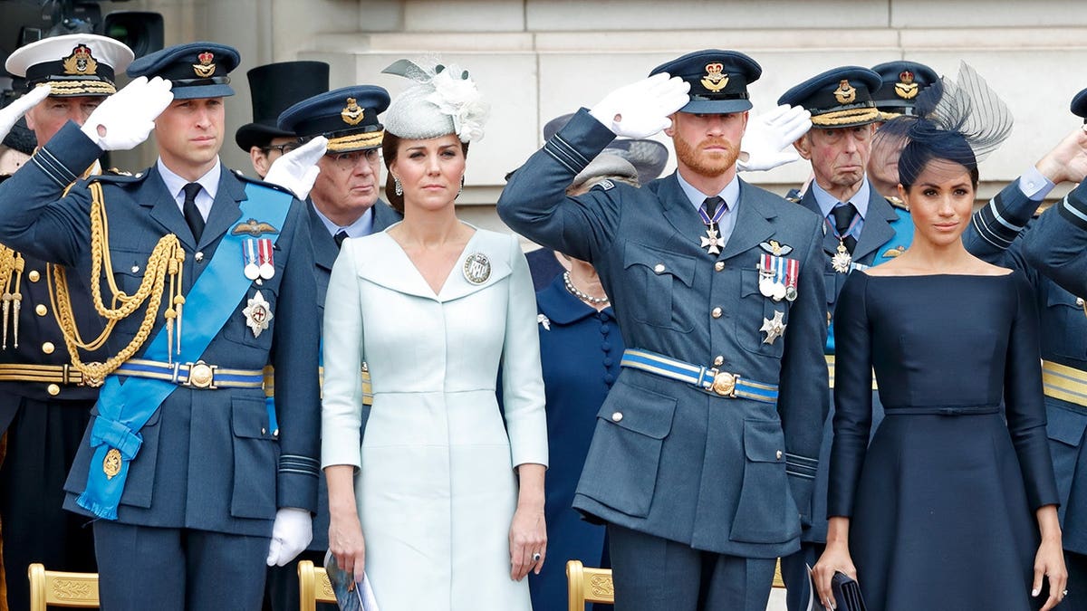 Prince William, Kate Middleton, Prince Harry and Meghan Markle standing together in formal wear honoring the Royal Air Force.