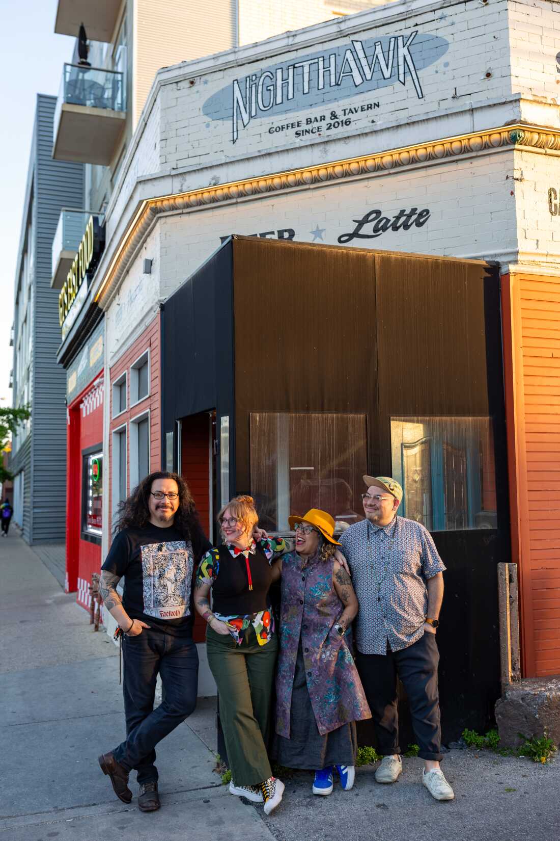 Bar co-managing partners Juan Bermudez, his wife Sam Bermudez, his sister Ana Bermudez and brother-in-law David Chavez pose for a portrait outside the entrance at Nighthawk in Chicago on May 15.