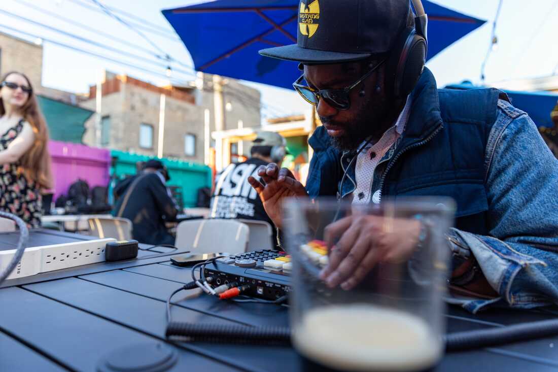 Flip a Beat Club Chicago (FABC) chapter participant and artist Slghtr! 13x works on his beats on his MPC (or "beat machine") at Nighthawk in Chicago on May 15.
