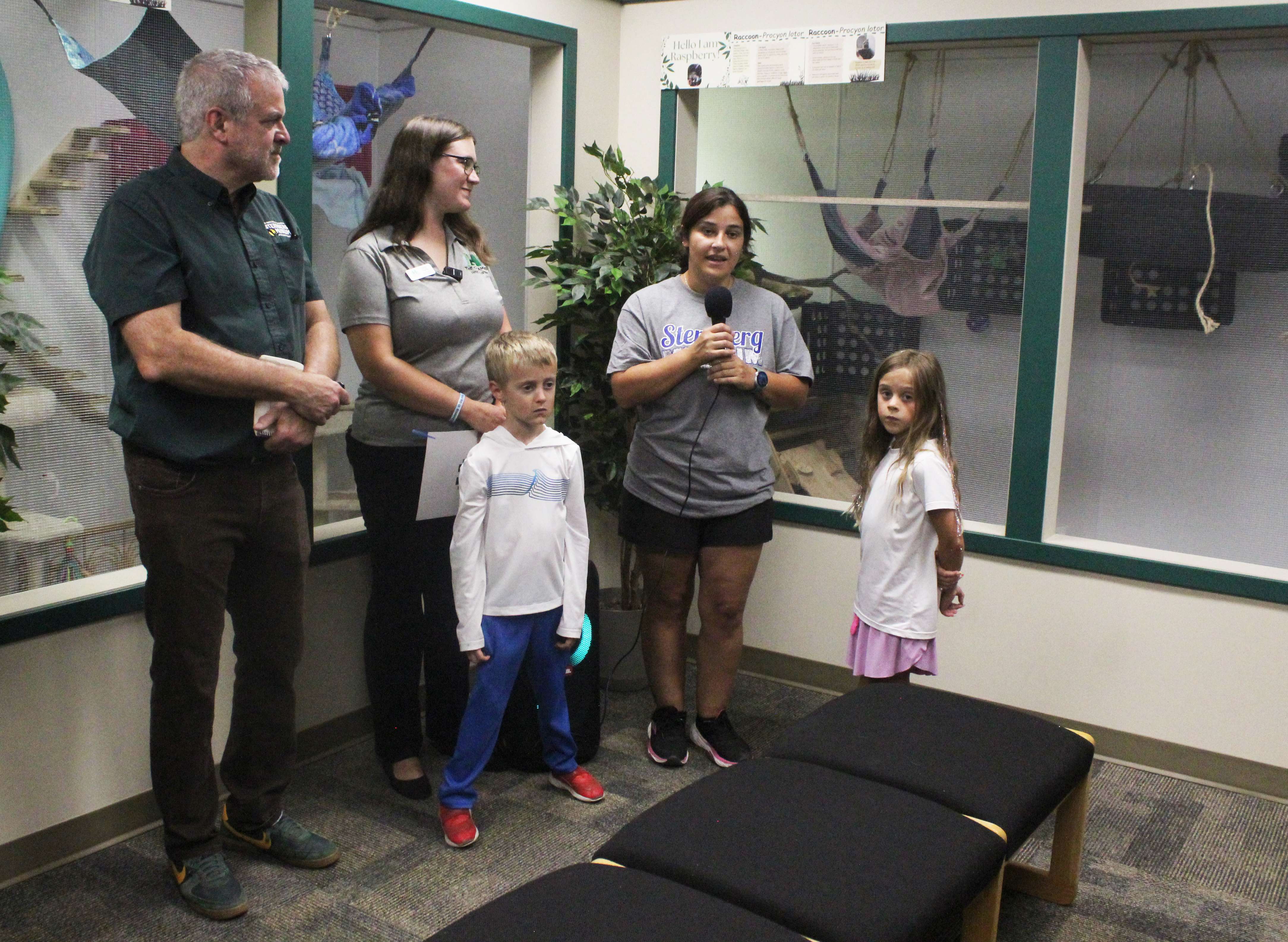 From left: Sternberg Executive Director Reese Barrick, Leigh Purdy of the Chamber in Hays, and Alicia Gaede, naturalist and education manager, in front of the new mammal habitats at the museum. Photo by Cristina Janney/Hays Post