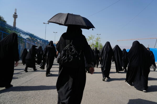 Mourners walk to a gathering commemorating the late Supreme Leader Ayatollah Ali Khamenei at the Imam Khomeini Mosalla Grand Mosque in Tehran, Tuesday, July 14, 2026. (AP Photo/Vahid Salemi)
