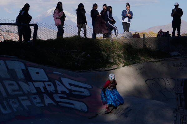 Miriam Fernandez, wearing a traditional Cholita skirt, known as a pollera, rides her skateboard during a youth talent show in La Paz, Bolivia, Thursday, July 16, 2026. (AP Photo/Juan Karita)
