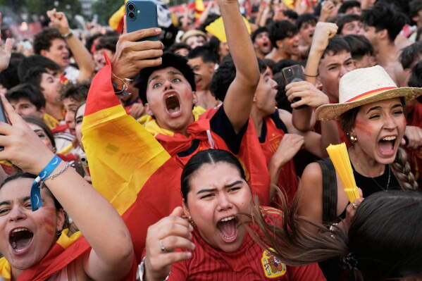 Spanish fans celebrate in central Madrid after Spain's Mikel Oyarzabal scored the opening goal on a penalty kick during the World Cup semifinal soccer match between France and Spain played in Arlington, Texas, near Dallas, Tuesday, July 14, 2026. (AP Photo/Bernat Armangue)