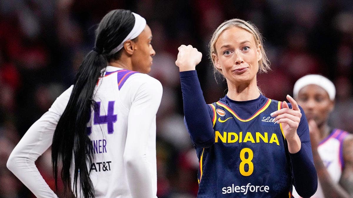 Indiana Fever guard Sophie Cunningham pointing at Phoenix Mercury forward-guard DeWanna Bonner during a basketball game.