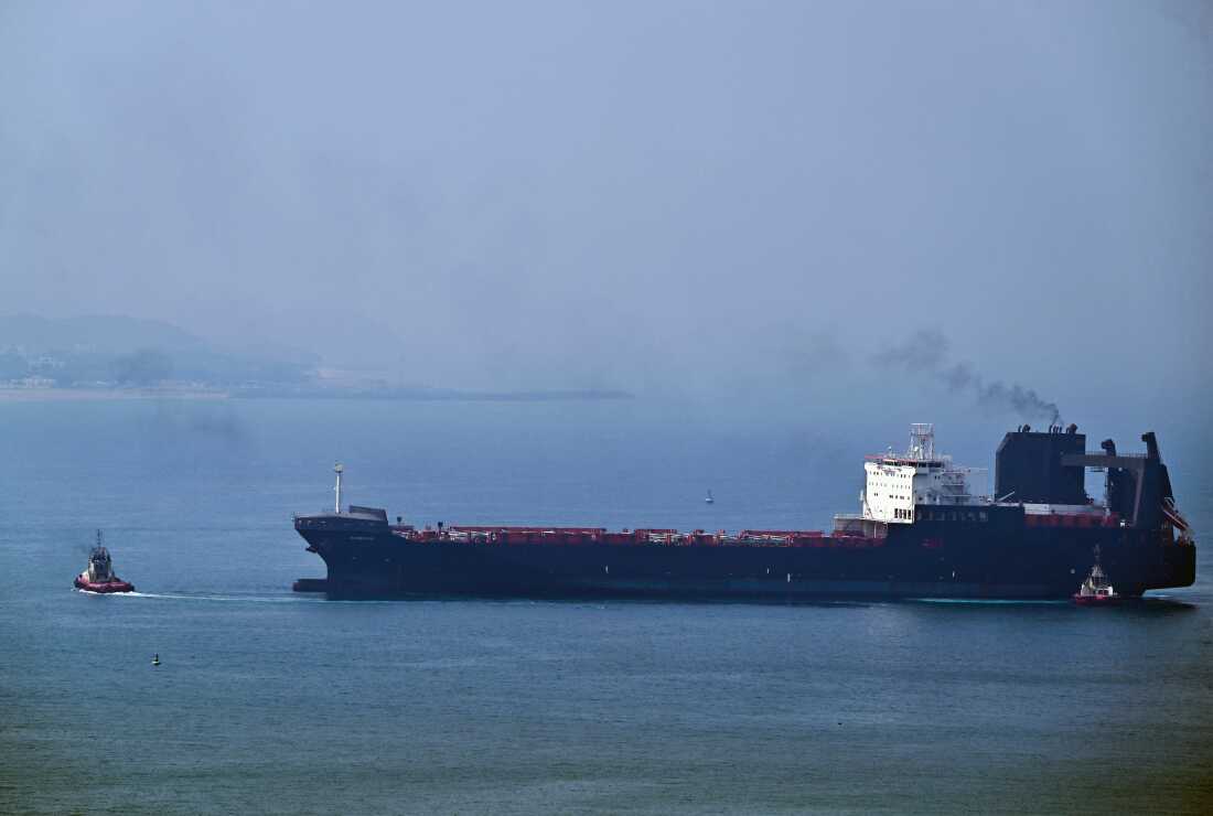A tugboat guides a ship at the Khor Fakkan Container Terminal, the only natural deep-sea port in the region and one of the major container ports in Sharjah Emirate, along the Gulf of Oman, on July 14.