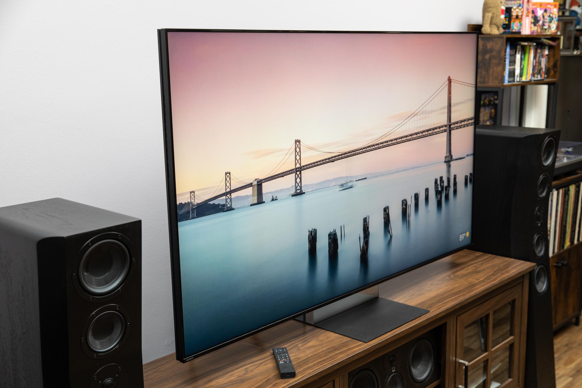 The Sony Bravia 9 II RGB LED TV on a wooden credenza with SVS speakers on either side.