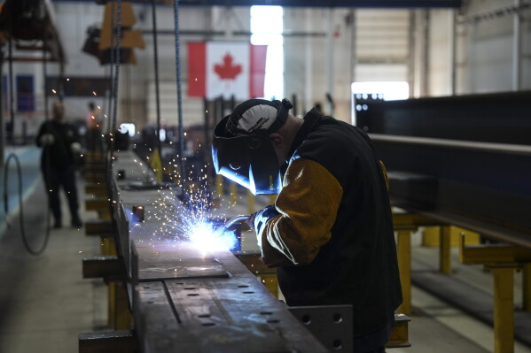 A welder works at Walters Group Steel fabrication plant in Hamilton, Ont., July 16, 2025. (Chris Young/The Canadian Press via AP)