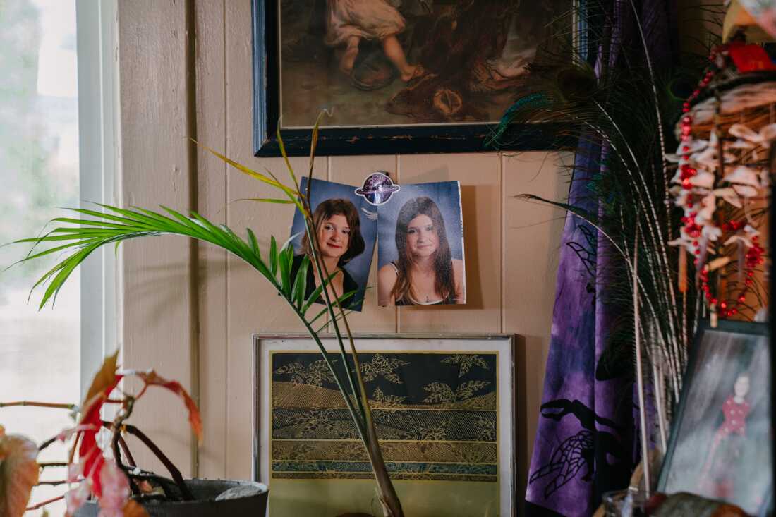 This photo shows a wall in Cody Coughenour's pleasant bedroom that has two large photos of a teenage girl tacked to the wall, along with other artwork.