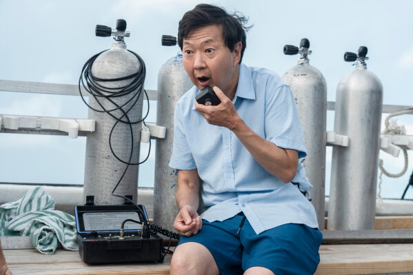 This image released by Discovery Channel shows actor-comedian Ken Jeong who appears in “K-Pop Shark Heroes," kicking off Discovery's annual "Shark Week." (Tito Herrera/Discovery Channel via AP)