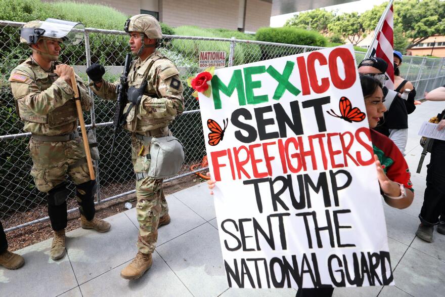 3BJBGBN Los Angeles, California, USA. 14th June, 2025. A protestor holds a sign that says Mexico sent firefighters, Trump sent the National Guard at the No Kings day protest in Los Angeles.