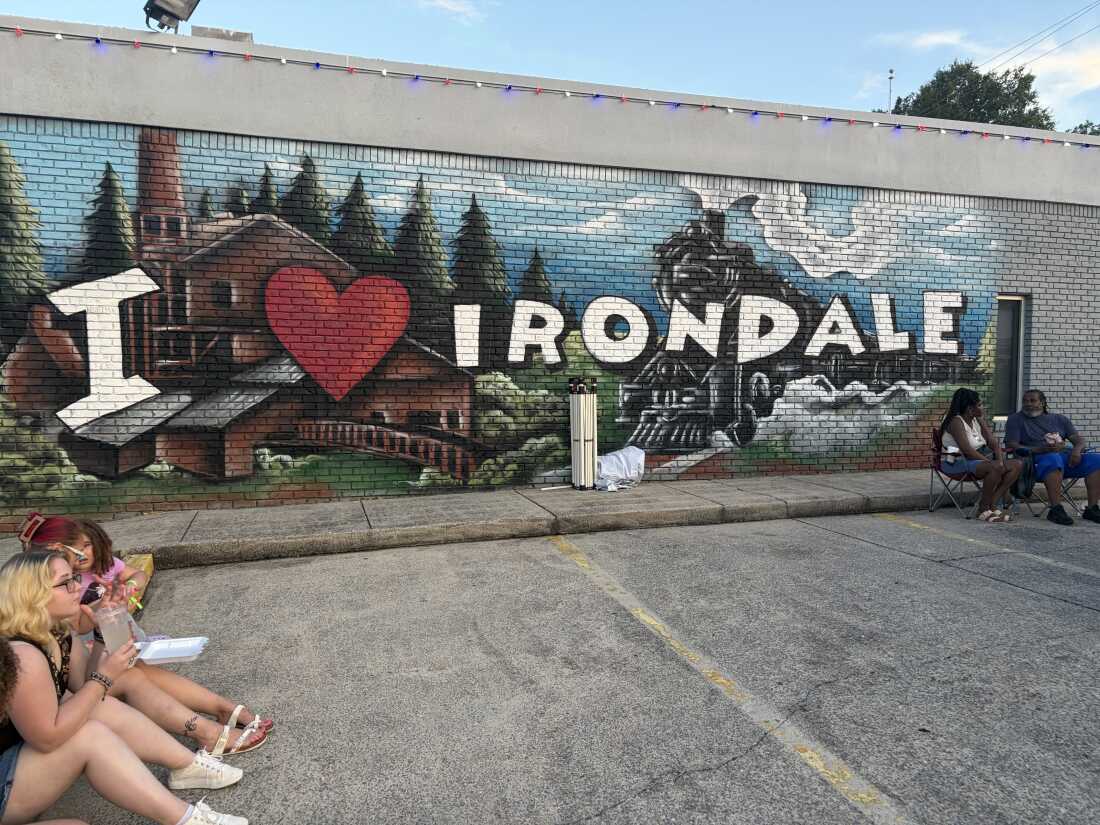 Festival-goers sit outside Irondale, Alabama's city hall on I Love Irondale Day, July 18, 2026.