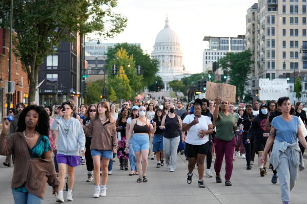 Protesters march after a Madison police officer shot and killed a man Wednesday, July 22, 2026, in Madison, Wis. (AP Photo/Kayla Wolf)