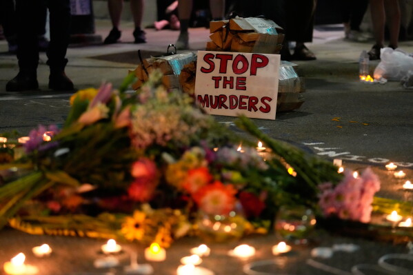Attendees gather at a candlelight vigil where a Madison police officer shot and killed a man Wednesday, July 22, 2026, in Madison, Wis. (AP Photo/Kayla Wolf)
