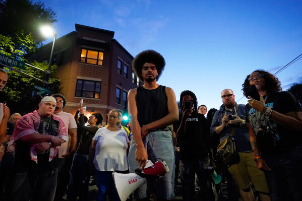 Attendees gather at a candlelight vigil where a Madison police officer shot and killed a man Wednesday, July 22, 2026, in Madison, Wis. (AP Photo/Kayla Wolf)