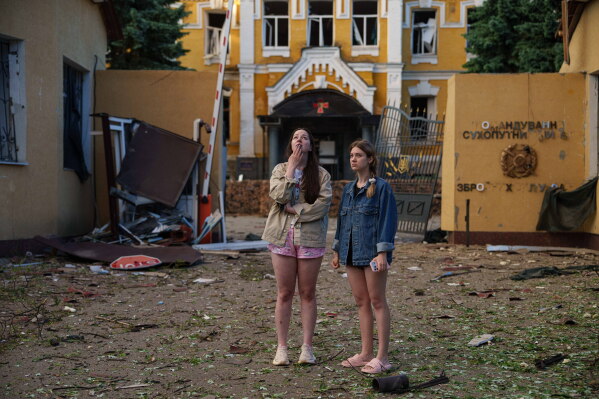 People look at a residential building after it was destroyed by a Russian strike in the Lukianivka neighbourhood of Kyiv, Ukraine, on Sunday, May 24, 2026. (AP Photo/Evgeniy Maloletka)