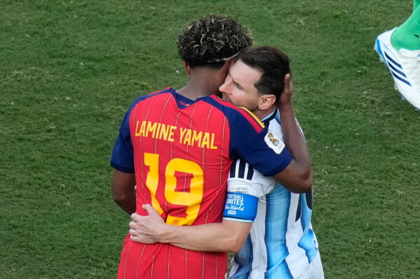 Spain's Lamine Yamal (19) and Argentina's Lionel Messi (10) embrace after during the World Cup final soccer match between Spain and Argentina in East Rutherford, N.J., near New York, Sunday, July 19, 2026. (AP Photo/Seth Wenig)