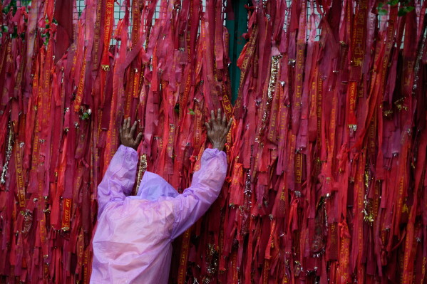 A stranded Hindu devotee prostrates at the starting point of the pilgrimage to the holy Vaishno Devi Temple in Katra, India, Tuesday, July 21, 2026, as the Mata Vaishno Devi Yatra remains suspended for a third day amid persistent heavy rainfall and adverse weather conditions. (AP Photo/Channi Anand)