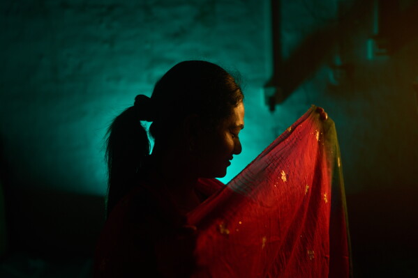Sujata Chaudhary, who is transgender and a former aid worker who turned to sex work to survive after losing her job amid the U.S. foreign aid cuts, poses for a photo in Kathmandu, Nepal, Friday, May 22, 2026. (AP Photo/Bram Janssen)