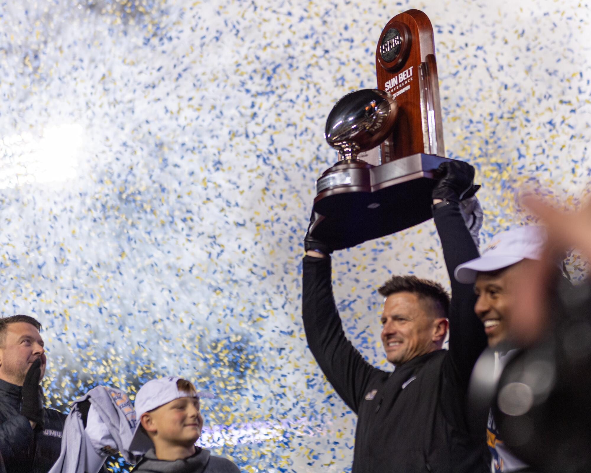 James Madison coach Bob Chesney and running back Wayne Knight celebrate after winning the Sun Belt championship.