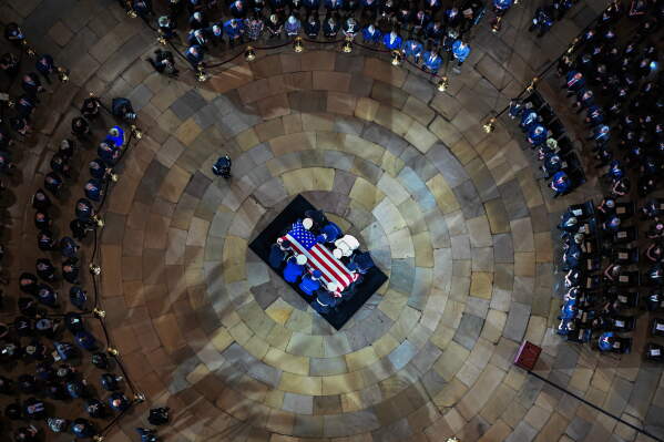 An Armed Forces Body Bearer Team moves the casket of Sen. Lindsey Graham, R-S.C., into the Rotunda of the U.S. Capitol for a Congressional tribute Tuesday, July 28, 2026, in Washington.(Kenny Holston/The New York Times via AP, Pool)