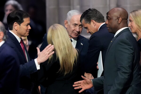 Israeli Prime Minister Benjamin Netanyahu, center, speaks to Secretary of Defense Pete Hegseth, right, as Secretary of State Marco Rubio, left, greets Sen. Tim Scott, R-S.C., before the funeral of Sen. Lindsey Graham, R-S.C., Tuesday July 28, 2026, at the Washington National Cathedral in Washington. (AP Photo/Jacquelyn Martin)