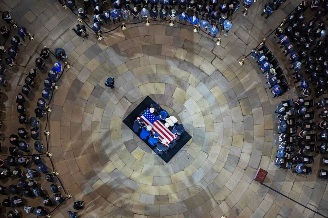 An Armed Forces Body Bearer Team moves Graham's casket in the Rotunda of the U.S. Capitol.