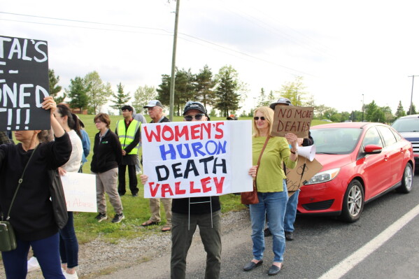 People protest outside of the Women's Huron Valley Correctional Facility in Washtenaw County, Mich., Wednesday, May 20, 2026, following the sudden deaths of two inmates within days of each other. (Janelle D. James/Bridge Michigan via AP)