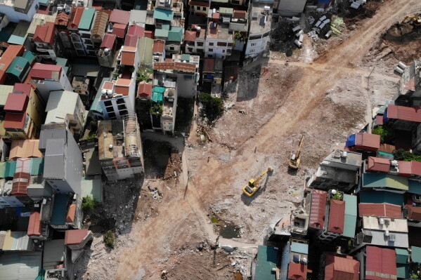 This aerial shot shows a ring road being built, cutting through a residential community in Hanoi, Vietnam, Monday, June 15, 2026. (AP Photo/Hau Dinh)