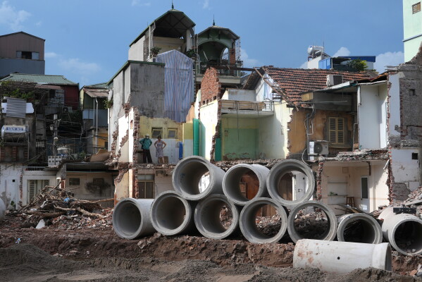 Local residents look out from their home, partially demolished to build a new ring road in Hanoi, Vietnam, June 15, 2026. (AP Photo/Hau Dinh)