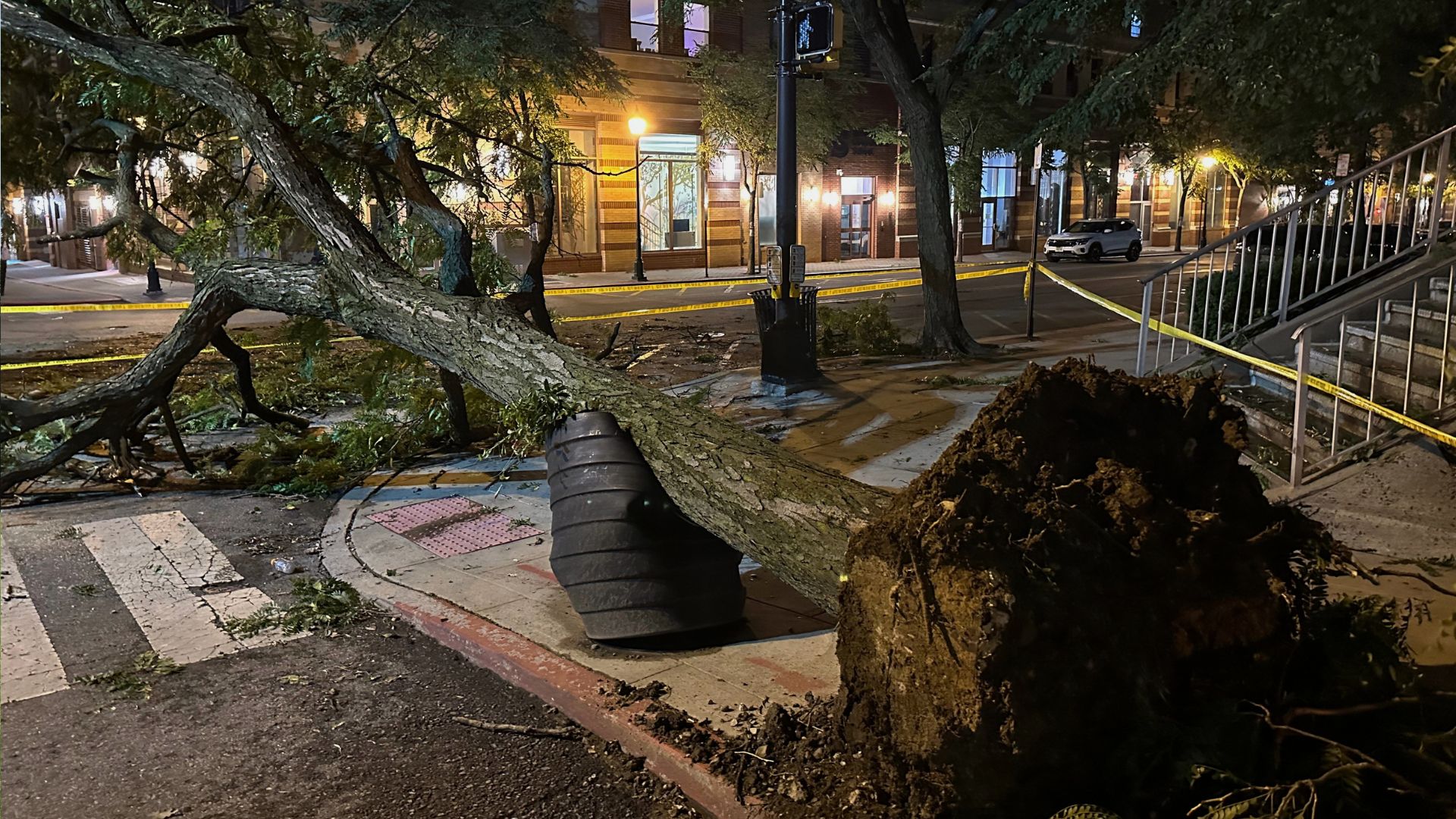 A tree ripped from the ground by a severe storm is surrounded by police tape in Hoboken, N.J., early Saturday, July 4, 2026.