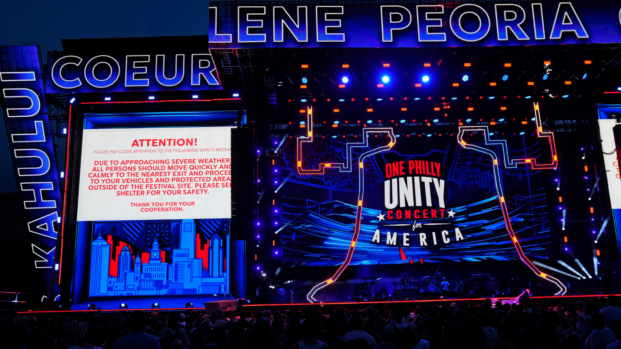 An announcement is posted that all concertgoers must leave the grounds due to an approaching thunderstorm during the One Philly: Unity Concert for America on July 4, 2026.