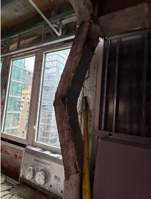 An image from inside the building shows a buckling beam.