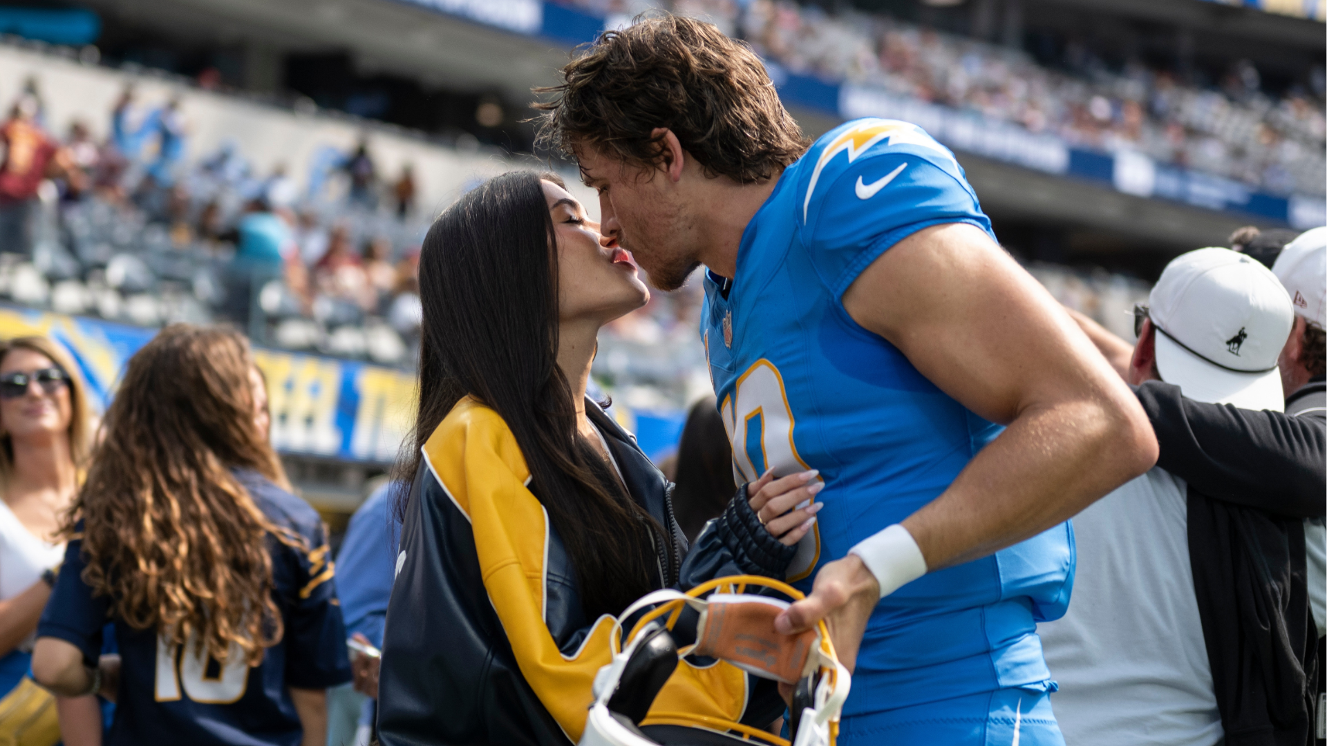 FILE - Los Angeles Chargers quarterback Justin Herbert, right, kisses Madison Beer before an NFL football game against the Washington Commanders, Sunday, Oct. 5, 2025, in Inglewood, Calif.