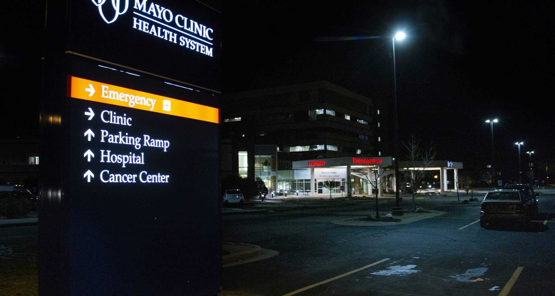Street lights shine on the Mayo Clinic parking lot at night