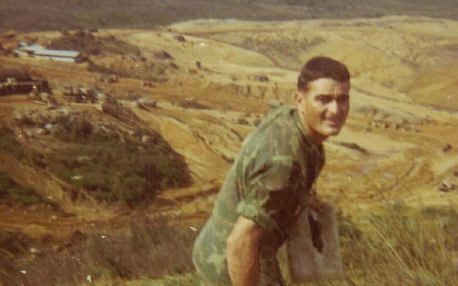 Barreto stand in a grassy, hilly field.