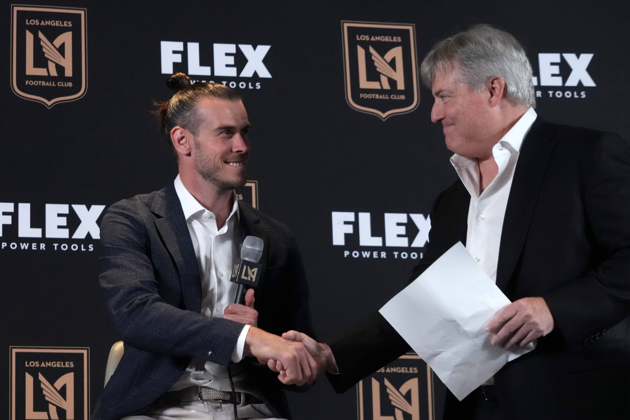 Gareth Bale shakes hands with LAFC owner Larry Berg
