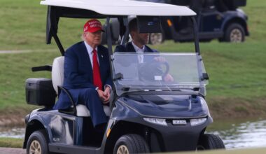 Apr 3, 2025; Miami, Florida, USA; President Donald Trump and his son, Eric Trump, drive in a golf cart after he arrived on Marine One at the LIV Golf Miami golf tournament at Trump National Doral.