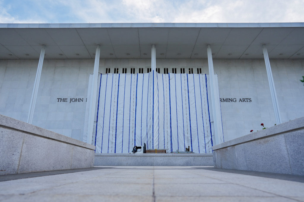 A tarp covers the facade of the John F. Kennedy Memorial Center for the Performing Arts, following a federal judge’s order...
