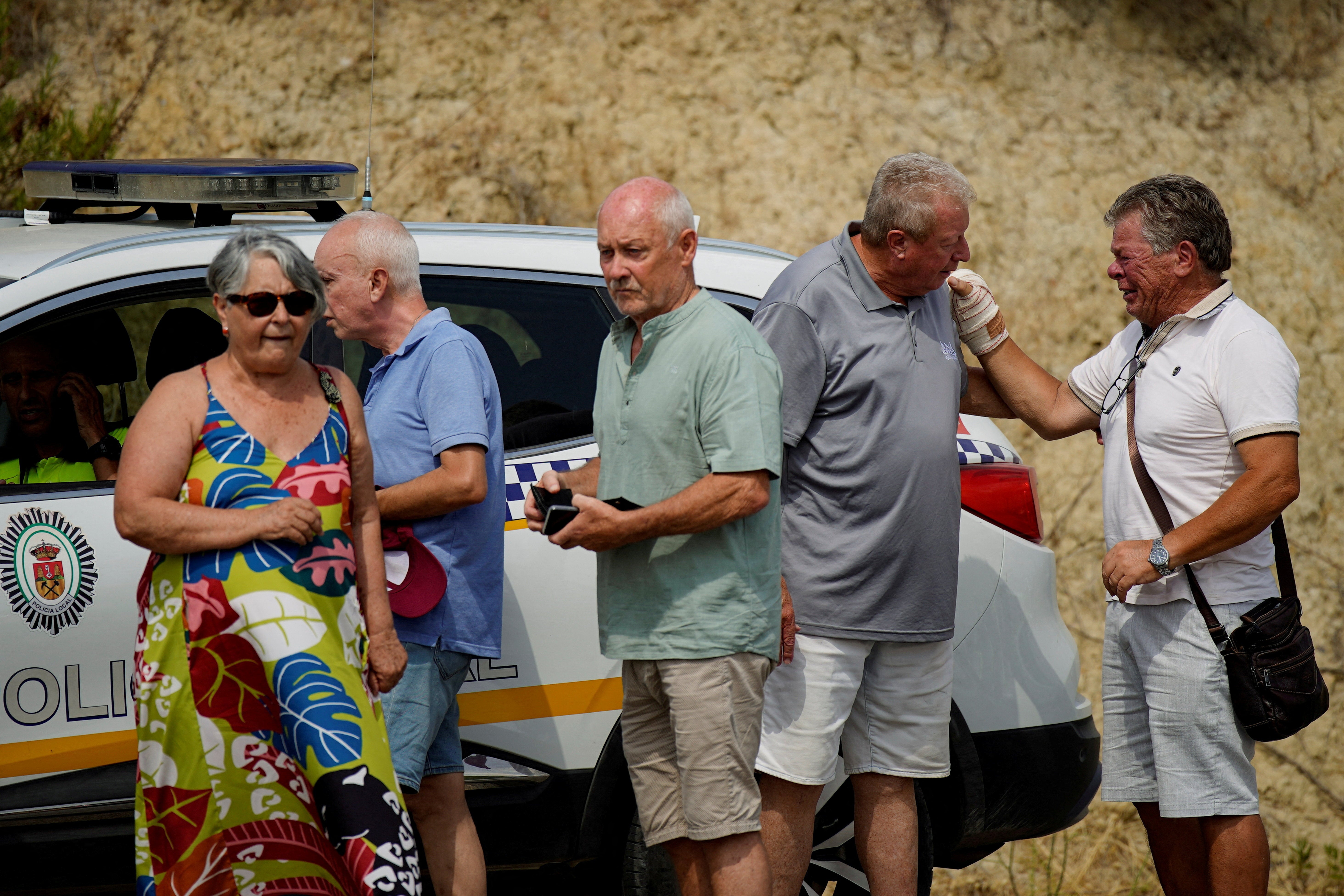 Residents affected by the fires wait for police to allow them to return to their homes – and to see what damage has been wrought