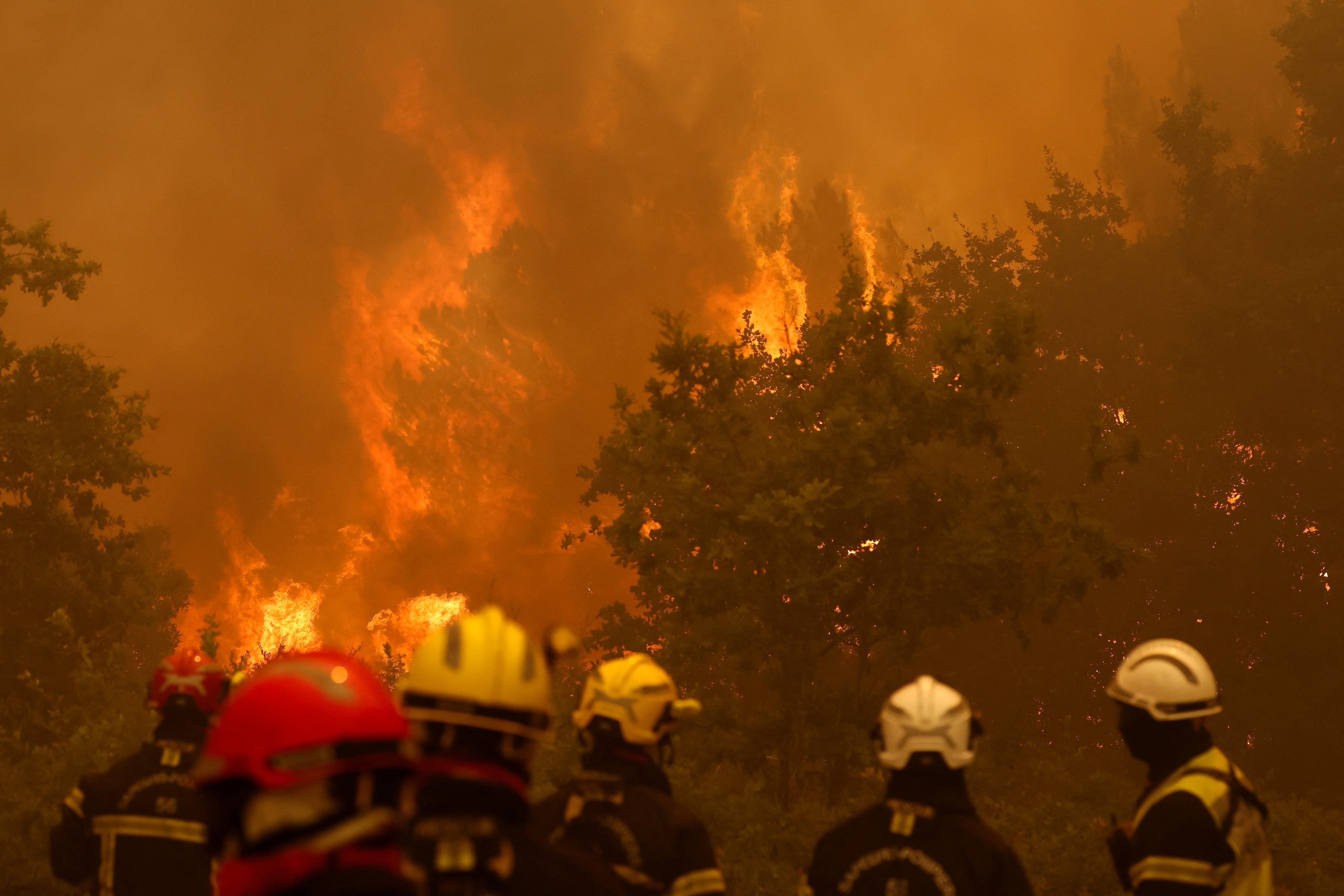 Firefighters work to extinguish flames during a wildfire in Lege-Cap-Ferret in the Gironde department, amongst worsening drought conditions following a heatwave and water shortages across much of France.
