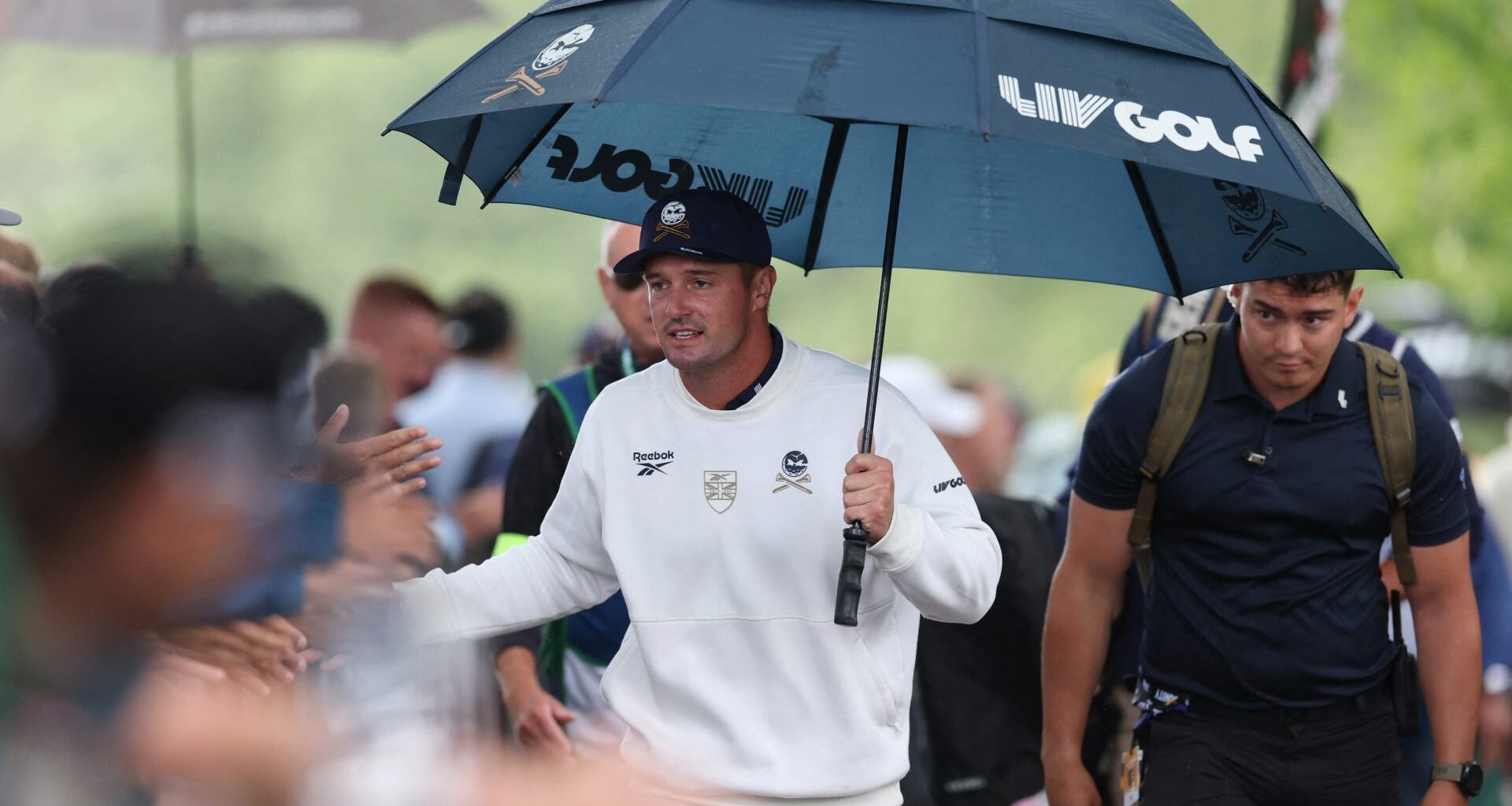 Golf - LIV Golf - United Kingdom - JCB Golf and Country Club, Uttoxeter, Britain - July 26, 2026 Crushers GC's Bryson DeChambeau holds an umbrella during the final round Action Images via Reuters/Paul Childs