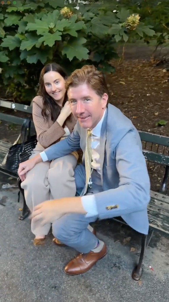 Kelsey Borenzweig and Nathaniel D. Cullerton sitting on a park bench.