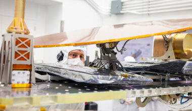 APL engineer Jackson Banbury inspects the motorized arm that attaches Dragonfly’s high-gain antenna to the spacecraft body.