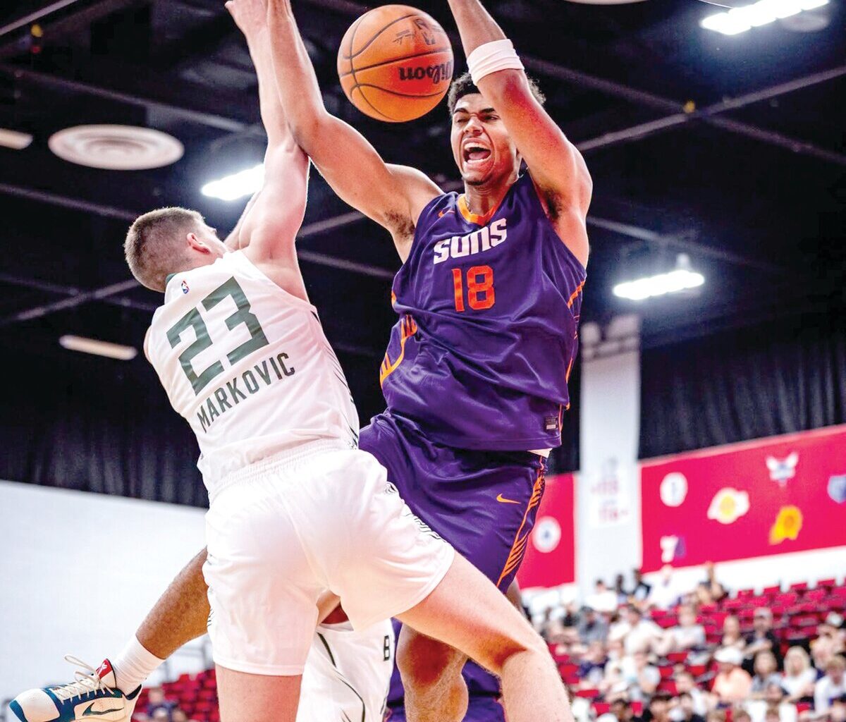 Suns forward Koa Peat (18) dunks over Milwaukee Bucks forward Bogoljub Markovic during an NBA Summer League game on Monday in Las Vegas.